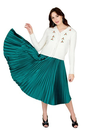 A Model Posing in an Internship Attire of a White Cardigan Paired with a Teal Pleated 